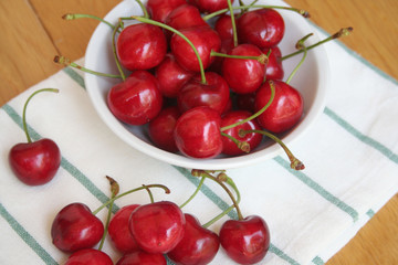 Ripe fresh cherries on a bowl oon wooden table