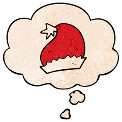 cartoon santa hat and thought bubble in grunge texture pattern style