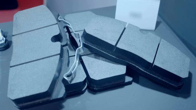 Set of new brake pads. A samples is presented for review at the exhibition. Shot in motion