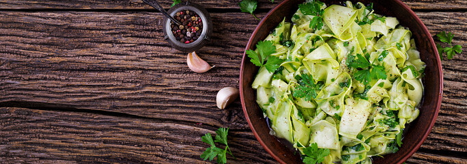 Salad of marinated zucchini in spices. Vegan food. Healthy meal. Banner. Top view