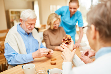 Caregiver cares for seniors in dementia therapy