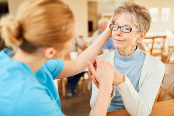 Fototapeta premium Caregiver consoles seniors with dementia