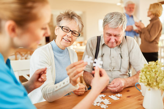 Senior and geriatrician playing puzzle