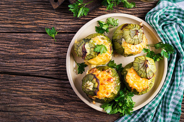 Zucchini stuffed with minced meat, cheese and green herbs. Baked in oven. Top view