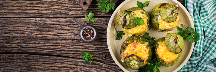 Zucchini stuffed with minced meat, cheese and green herbs. Baked in oven. Banner. Top view