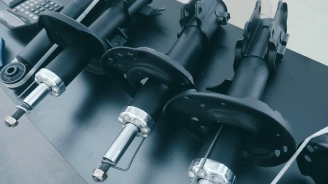 New car struts of dampers is presented for review at the exhibition. Shot in motion