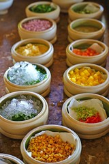 Mise en place of little dishes with ingredients for making tropical ceviche