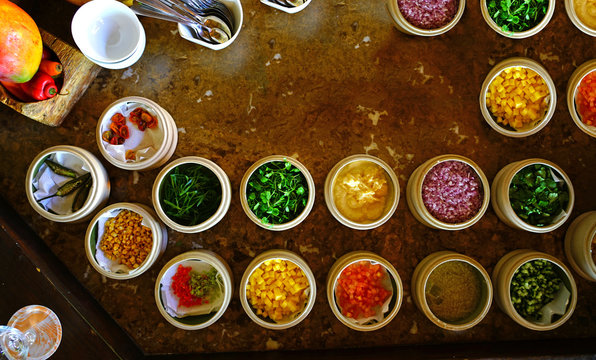 Mise en place of little dishes with ingredients for making tropical ceviche