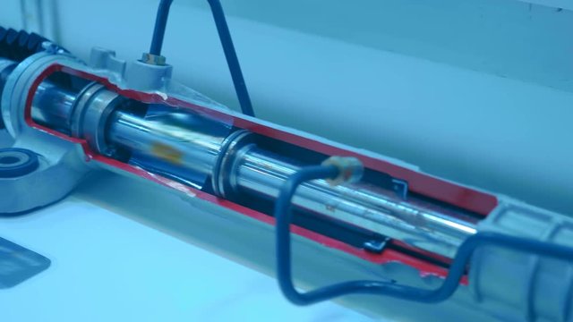 The car steering rack in the cutting is showing the principle of its work is presented for review at the exhibition. Shot in motion