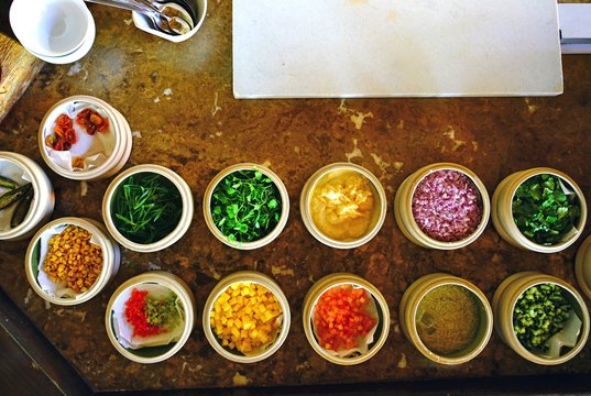 Mise en place of little dishes with ingredients for making tropical ceviche