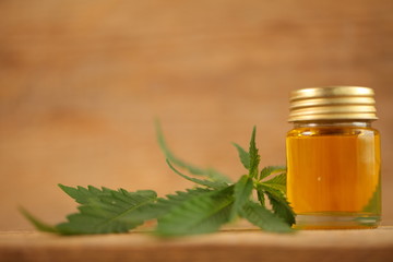 cbd oil bottle and hemp leaf