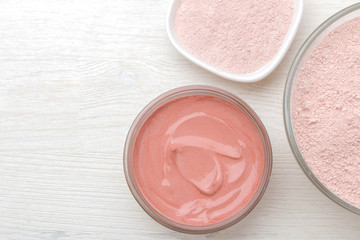 Obraz na płótnie Canvas Cosmetic clay. Pink cosmetic clay in different types on a white wooden table. face mask and body. care products. spa. top view.
