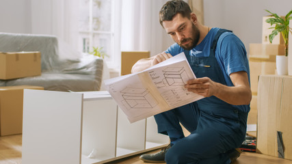 Successful Furniture Assembly Worker Reads Instructions to Assemble Shelf. Professional Handyman...