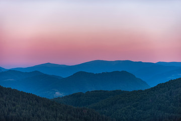 Majestic purple sunset in the mountains landscape. Dramatic scene. 
