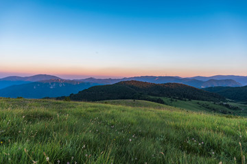 Obraz premium Amazing mountain landscape with colorful vivid sunset on clear sky, natural outdoor travel background