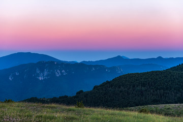 Amazing mountain landscape with colorful vivid sunset on clear sky, natural outdoor travel background