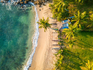 Romantic sunset on a tropical beach with palm trees