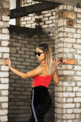 Sporty chic woman posing at abandoned construction site