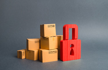 A stack of cardboard boxes and a red padlock. concept of insurance purchases. Consumer rights...