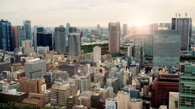 Aerial view of downtown Tokyo buildings with a sunset
