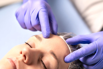 Cosmetologist, plastic surgeon or doctor with patient or customer. Consultation and plan before...