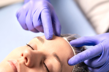 Cosmetologist, plastic surgeon or doctor with patient or customer. Consultation and plan before facial surgery in hospital, skin treatment or facelift in clinic. Professional skincare in beauty salon.