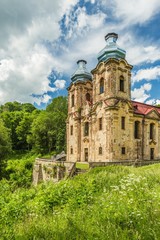Fototapeta na wymiar Skoky, Zlutice / Czech Republic - June 21 2019: Baroque church of the Virgin Mary Visitation in Skoky, Maria Stock, is a former pilgrimage place in West Bohemia. Sunny day, blue sky with clouds.