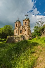 Fototapeta premium Skoky, Zlutice / Czech Republic - June 21 2019: Baroque church of the Virgin Mary Visitation in Skoky, Maria Stock, is a former pilgrimage place in West Bohemia. Sunny day, blue sky with clouds.