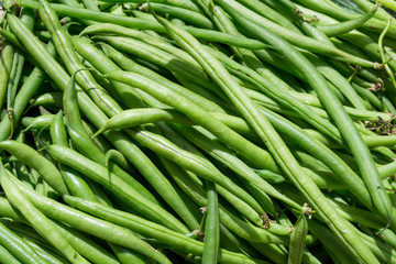 Fresh green pods of black eyed peas at the market