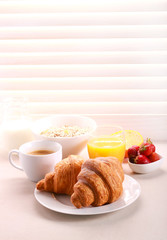 Breakfast with croissant, orange juice