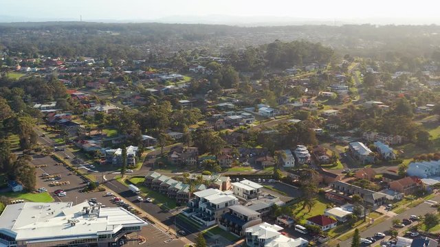 Aerial, reverse, drone shot over the Mollymook village, on a sunny, summer day, in Shoalhaven region, New South Wales, Australia