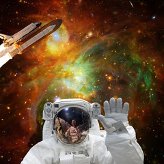 Obraz na płótnie Canvas Astronaut posing. Rocket on the backdrop. The elements of this image furnished by NASA.