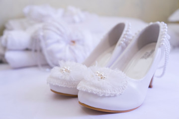 white wedding shoes and flowers