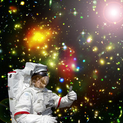 Astronaut gives thumbs-up against outer space, galaxies and stars. The elements of this image furnished by NASA.