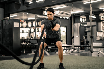 Fototapeta na wymiar Fit young man workout in a gym