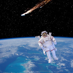 Meteor rain and astronaut. The elements of this image furnished by NASA.