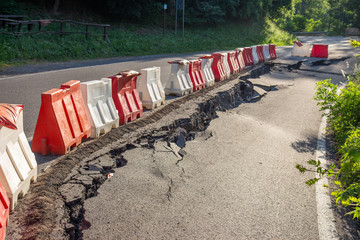 Landslide hit by flooding and road subsidence