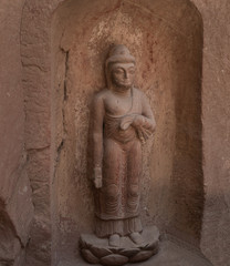 Relief of a standing Buddha in niche 13 carved in Tang Dynasty in Bingling Temple and Grottoes, Yongjing, Gansu, China. UNESCO World Heritage Site.