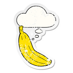 cartoon banana and thought bubble as a distressed worn sticker