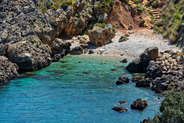 The crystal clear waters waters of Cala Beretta in the Oasi dello Zingaro natural reserve, San Vito Lo Capo, Sicily