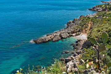 Fototapeta na wymiar The crystal clear waters waters of Cala Beretta in the Oasi dello Zingaro natural reserve, San Vito Lo Capo, Sicily
