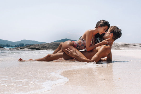 Beautiful models passion couple kissing and embracing in the sea water. Phuket. Thailand
