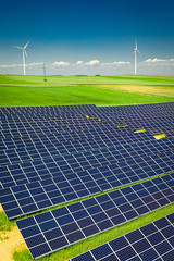 Stunning view of solar panels on green field, aerial view