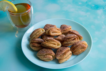 Biscuits with cottage cheese, tea with lemon and raspberry jam