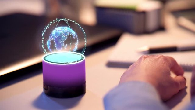 business, technology and internet of things concept - close up of businesswoman using smart speaker with virtual earth hologram at office