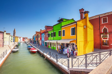Fototapeta na wymiar Multicolored houses on Burano island, Venice, Italy, on a summer day. Architecture and travel background.