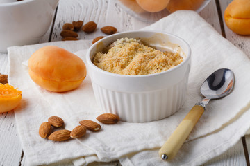 Crumble apricot pie on white table, morning dessert