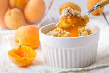 Crumble apricot pie on white table, morning dessert