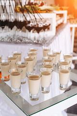 Festive table with cold exotic alcoholic beverages, cocktails and fruits. Celebration or other event
