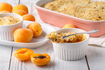 Crumble apricot pie on white table, morning dessert
